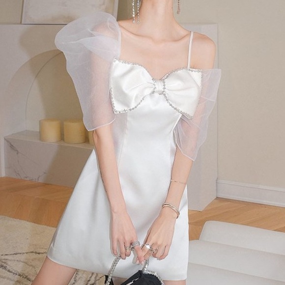 Dresses & Skirts - Size 6. White dress with bow, rhinestones, and tulle puff sleeves.